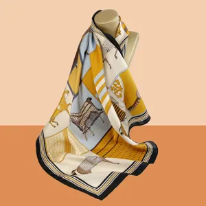 Close-up detail of luxury silk square scarf featuring elegant equestrian and vintage motifs.