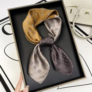Detail view of luxurious mulberry silk square scarf featuring elegant gradient geometric print.