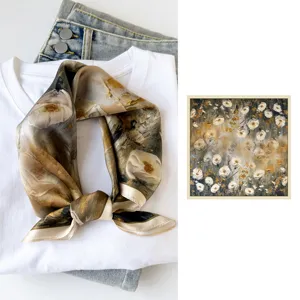 Exquisite silk square scarf detail showing artistic oil painting floral print and smooth fabric.