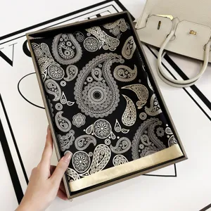 Luxury black silk scarf with elegant gold paisley print, premium square satin silk for women.