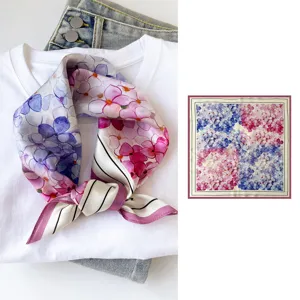 Silk square scarf detail featuring delicate blue and pink floral watercolor print design.