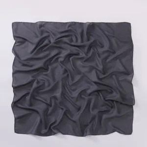 Dark grey cotton linen square scarf detail, soft fabric texture, close-up view of hijab.