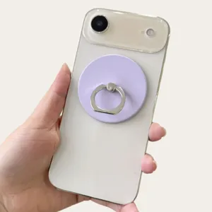 Close-up of a light purple magnetic phone ring holder attached to a white smartphone