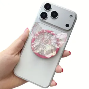 Macro detail showing iridescent butterfly pop socket attached to white smartphone back
