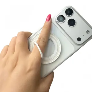 Close-up detail of white magnetic ring phone holder with elegant shell texture