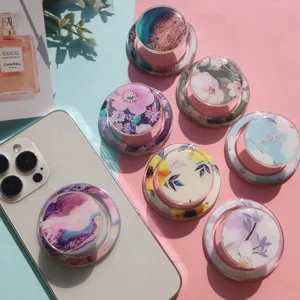 Close-up of various floral and marble epoxy pop-up phone sockets on a pastel background.