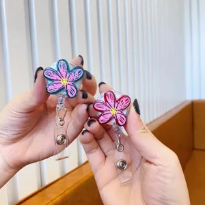 Detailed macro view of cute pink graffiti flower retractable badge reels for nurse ID tags
