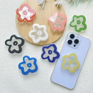 Vibrant acrylic flower-shaped collapsible phone grip stand in various colors for smartphones