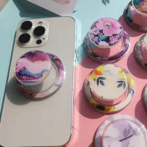 Floral and marble magnetic phone pop sockets in various designs on split background