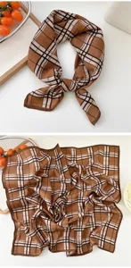 Brown plaid small square scarf detail view showing classic checkered pattern and neat brown border.