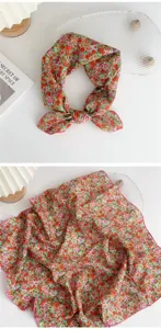 Detailed view of floral cotton linen square scarf, showcasing vibrant print and neat rolled edges.