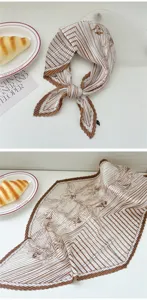 Detail view of pleated square scarf with brown stripe floral print, elegant accessory style.