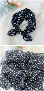 Detailed view of black floral cotton linen square scarf, showing delicate fabric and pattern.