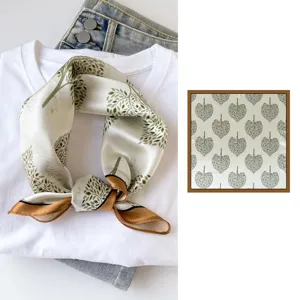 Silk square scarf featuring an elegant green tree leaf print and stylish brown border for women.