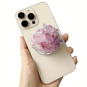 Close-up detail of a purple amethyst-style acrylic phone grip attached to a smartphone