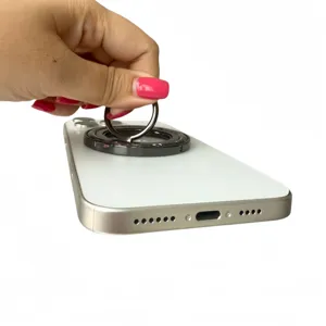 Close-up of a white 360-degree rotating magnetic ring holder shown in use on a phone