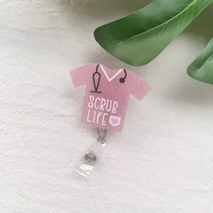 Close-up detail of a pink glitter nurse scrub badge reel featuring Scrub Life text.