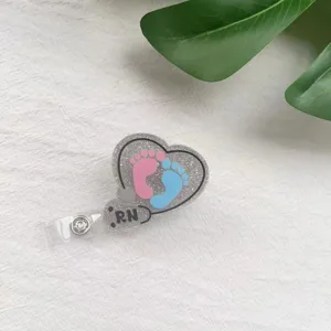 Heart-shaped glitter RN nurse badge reel with cute baby footprints