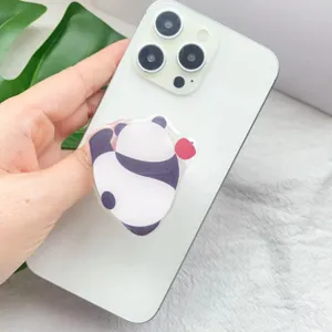 Close-up view of a cute panda acrylic retractable phone grip on a white smartphone