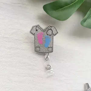 Retractable badge holder featuring glittery nurse scrub design with baby footprints