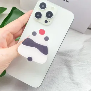 Macro detail of a cute panda acrylic expandable phone grip on a white iPhone case