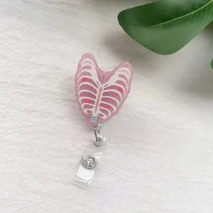 Detail view of pink glitter ribcage retractable badge reel for nurse identification