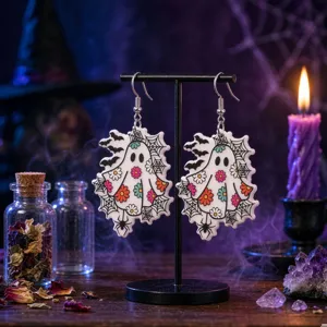 Detailed macro view of Halloween ghost acrylic earrings with floral and spiderweb prints