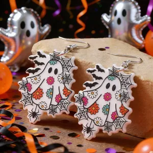 Close-up of Halloween ghost acrylic earrings with colorful floral prints and spider webs