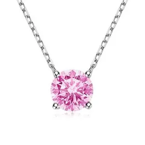 Macro detail of a 925 sterling silver necklace featuring a round pink gemstone pendant.