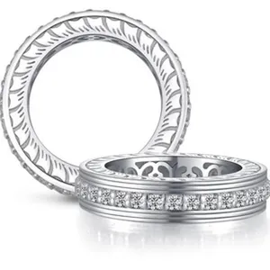 Detailed macro view of two sterling silver s925 rings with intricate engraved patterns