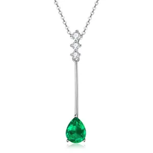 Detailed view of an elegant silver necklace featuring a pear-shaped green gemstone