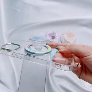 Detailed view of a clear phone case with a blue dried flower MagSafe magnetic grip.