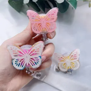 Detailed view of resin butterfly badge reels with elegant gold foil and floral patterns.