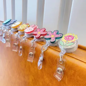 Macro view of cute cartoon retractable badge reels with colorful doodle flower designs