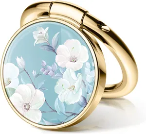 Detailed macro view of a golden mobile phone ring holder with elegant blue floral pattern