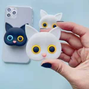 Detailed view of cute white and black cat-shaped collapsible phone socket grips