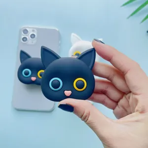 Cute black cat phone socket with heterochromia eyes shown held by a hand for scale.