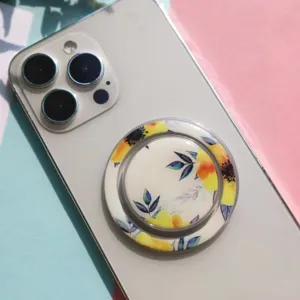 Detailed view of a floral print collapsible magnetic phone grip on a white smartphone