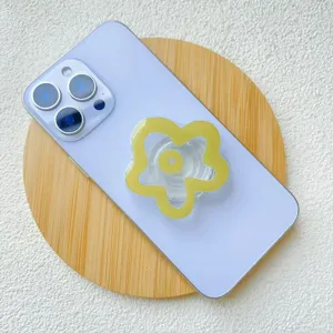 Chic yellow flower acrylic expandable phone grip stand on a light purple smartphone