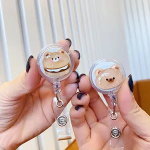 Detailed macro view of cute cartoon bear retractable badge reels with glitter