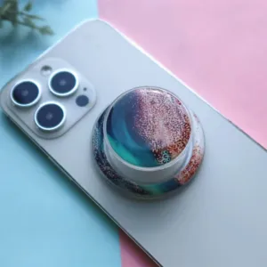 Detailed macro view of colorful marble pattern resin phone grip stand on white smartphone back