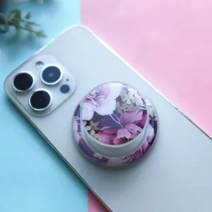 Detail view of a stylish floral drip glue magnetic phone grip holder on a smartphone