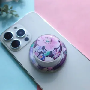 Macro view of a stylish floral magnetic phone grip with glossy resin finish and pink flowers