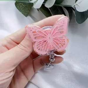 Retractable butterfly badge reel featuring pink resin with elegant gold foil details