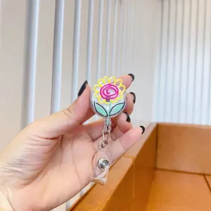 Close-up of cute cartoon flower retractable badge reel with crocodile clip for nurses