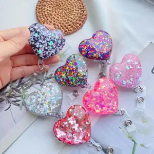 Nahaufnahme von glitzernden, herzförmigen, ausziehbaren Ausweishaltern in bunten Farben