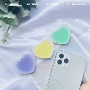 Close-up of gradient heart-shaped air cushion phone grips in purple yellow and green