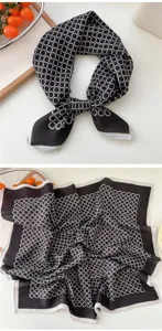Close-up detail of the black and white chain pattern square scarf, showing fabric texture and edge.