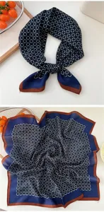 Close-up detail of the navy blue cotton-linen square scarf with geometric pattern and brown border.
