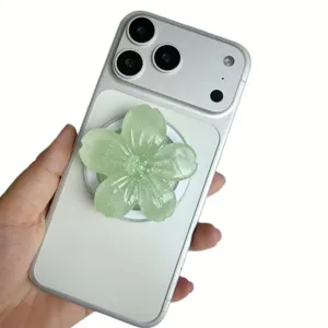 Glitzernde hellgrüne 3D-Resin-Blume magnetische klappbare Handyhalterung auf einem Smartphone